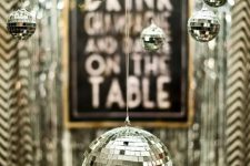 hang some silver disco balls on your chandeliers and lamps and they will instantly create a party feel in the spaces