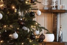 stylish Christmas tree decor with black, white and brown ornaments and lights is a super catchy and cool idea