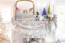 super shiny and bright NYE decor in silver, with disco balls, garlands, lights and a silver Christmas tree is wow