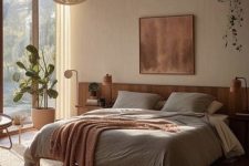 04 a light-filled earthy bedroom with windows and a glazed wall, a bed with neutral bedding, nightstands with lamps and greenery
