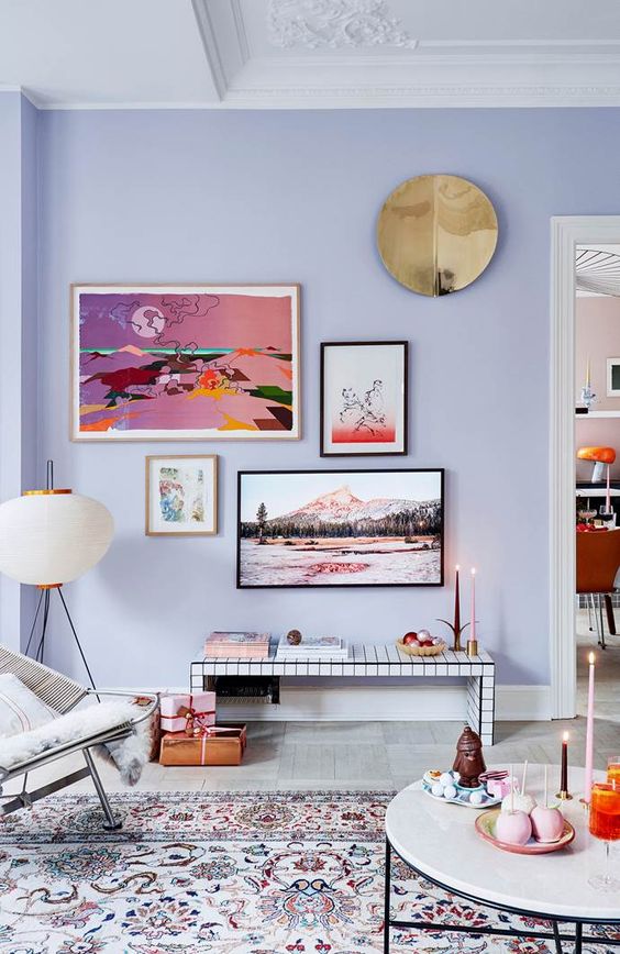 An eclectic living room with lilac walls, a tiled bench, a colorful gallery wall, mid century modern furniture