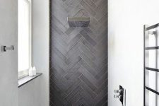 13 a chic contemporary shower space with white walls and an accent graphite grey skinny tiles clad in a chevron pattern and extended to the floor