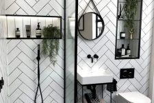15 a small contemporary bathroom with herringbone clad tile walls, a printed floor, a small sink and a shower with a glass divider