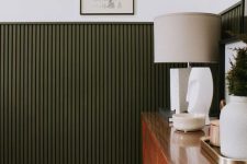 18 elegant dark green fluting accents everything that is in its backdrop and adds color and texture to the space