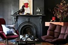 22 a moody living room with a an antique fireplace, burgundy seating furniture, some decor and a round coffee table