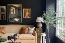 24 an elegant black living room with a tan sofa, a coffee table with books and decor, a potted plant and some art