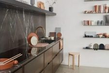 26 a chic contemporary kitchen with dark-stained cabinets, a black soapstone backsplash and countertops, an open shelf and some pretty tableware