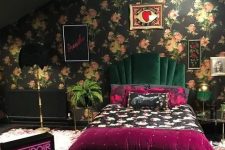 31 a dark maximalist bedroom with a dark floral accent wall, a dark green velvet bed, a feather chandelier, bold floral and purple bedding and a neon light