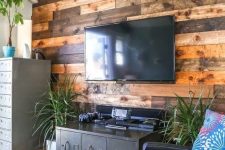 36 a weathered and stained wood accent wall softens the industrial-inspired living room with vintage touches