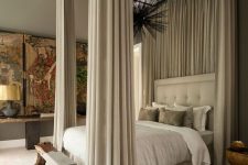 38 a sophisticated neutral bedroom with an upholstered bed and neutral bedding, a bench, a console table and bold artwork