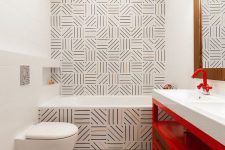 38 unique graphic tiles, a red vanity and red fixtures are a cool combo for a bold and catchy bathroom