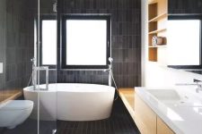 45 a contemporary bathroom all clad with matte dark skinny tiles and refreshed with light colored wood and white pieces