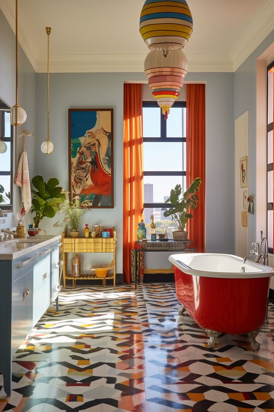 A dopamine infused bathroom with blue walls, a bold floor, a blue vanity, a red bathtub and bold artwork