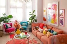 48 a bright dopamine-infused living room with blush walls, an orange sofa, fuchsia and teal chair, bold artwork