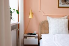 a Peach Fuzz accent wall paired with neutrals creates a soft and warm ambience where you’ll really want to be