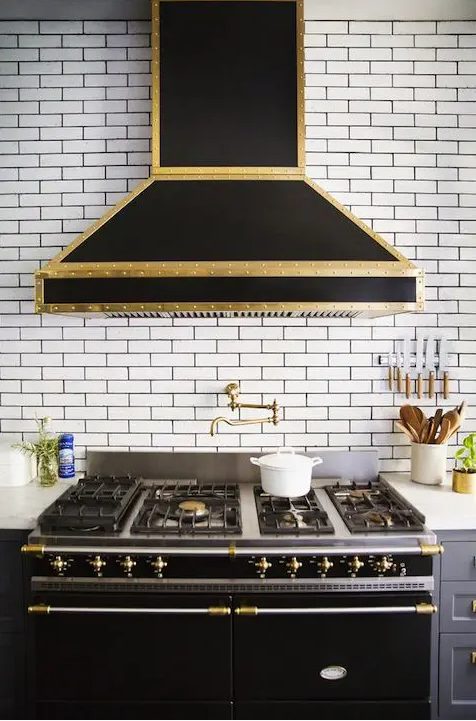 A beautiful vintage inspired black and gold metal hood is a gorgeous idea to bring a touch of retro and color to the space