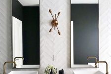 a bold art deco bathroom with white skinny tiles clad in a chevron pattern and a terrazzo floating vanity