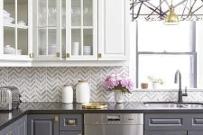 a bold kitchen with a grey and white chevron tile backsplash and a geo roman shade