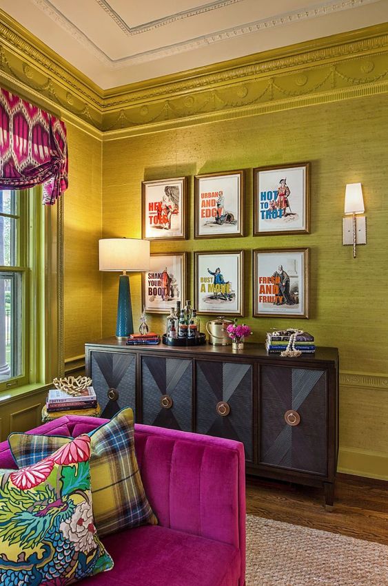 a bright and sophisticated living room with chartreuse walls, a refined credenza, a fuchsia sofa, bold curtains and a gallery wall