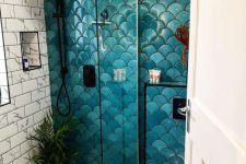 a catchy bathroom done with subway marble, pnny and bold teal and turquoise fishscale tiles, with black fixtures