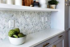 a gorgeous kitchen with a marble backsplash