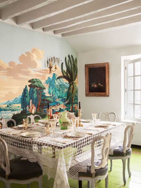 a chartreuse floor and a bold wall mural make this dining room unusual, and vintage furniture creates a contrast