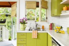 a chartreuse kitchen with a white subway tile backsplash and white countertops and bold shades and linens