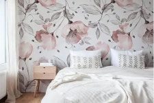 a chic bedroom with a pink floral accent wall, a bed with neutral bedding, a stained bench and a nightstand plus a neutral rug