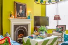 a colorful and eclectic living room with chartreuse walls, a fireplace, a bold printed ottoman, navy chairs and a sofa, a catchy chandelier