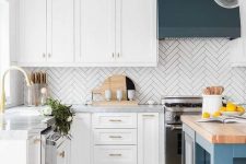 a gorgeous modern kitchen with teal and blue accents, butchblock tabletop and a white skinny tile backsplash in a chevron pattern