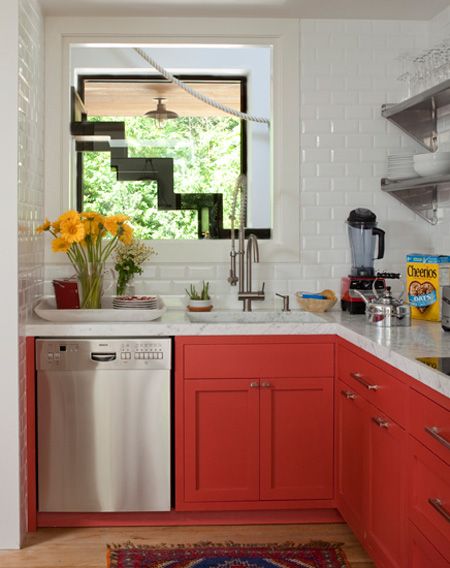 A hot red L shaped kitchen with shaker cabinets, white subway tiles, open shelves and stainless steel appliances