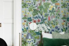 a lively and bold bedroom accented with bright floral wallpaper and with green bedding that matches the wallpaper