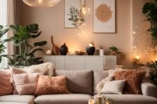a lovely earthy living room with beige walls, a greige sofa with pillows, a low coffee table, a brown pouf and greenery