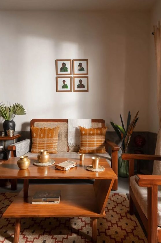 A mid century modern living room in earthy tones, with a wicker loveseat and chair, a tiered coffee table and some plants