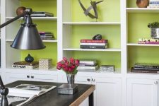 a modern white bookcase gets a new look with chartreuse backing, which makes all the pieces inside stand out a lot