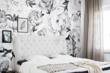 a monochromatic bedroom with a floral print wall that adds a bold print touch to the space