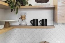 a neutral kitchen with wooden shelves and a white fishscale tile backsplash for a fresh and airy feel