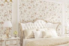 a neutral refined bedroom with floral wallpaper, a vintage bed with neutral bedding, refined nightstands and lamps