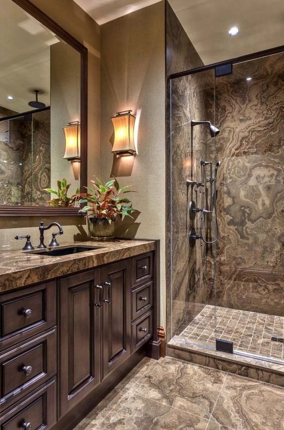 a refined and whimsical bathroom in brown and taupe shades, with vintage furniture and fixtures and catchy sconces