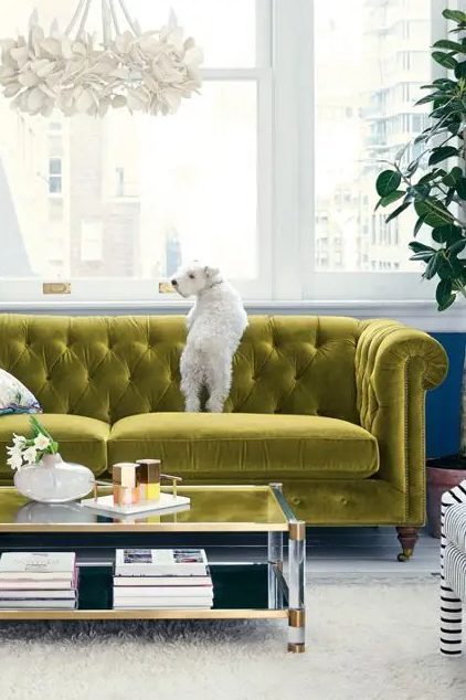 a refined chartreuse tufted sofa is a cool color statement in this neutral glam living room and it looks amazing
