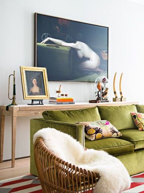 a refined eclectic living room with a long console table, a chartreuse sofa with pillows, a chair and some art