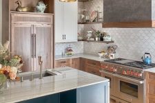 a refined stained kitchen with a neutral scallop tile backsplash, open shelves, a navy kitchen island and grey lamps
