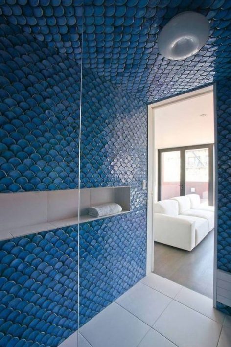 a shower space completely covered with blue fishscale tiles looks really mermaid-like and bold, your shower will stand out with such tiles for sure