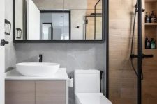 a small contemporary bathroom with a floating vanity, a shower space clad with wood tiles, a chevron floor, black touches for a contrast