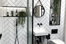 a small contemporary bathroom with herringbone clad tile walls, a printed floor, a small sink and a shower with a glass divider