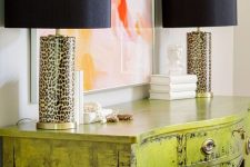 a super glam chartreuse console table with a brushed finish and leopard table lamps is wow