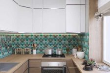 a two-tone kitchen with white and stained cabinets, a bright turquoise, green and brown scallop tile backsplash