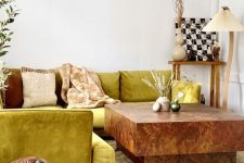 a unique living room with a chartreuse sofa, a stone coffee table, some decor and lamps plus a basket with a lid