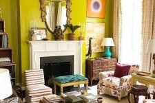 an eclectic chartreuse living room with a fireplace, a couple of sofas, a coffee table and stools and some decor