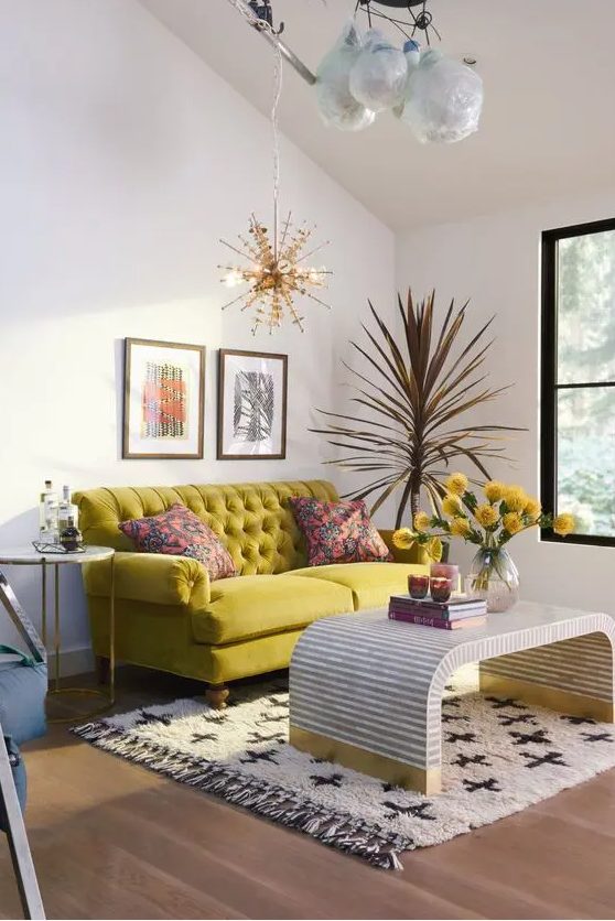 an eclectic living room with an attic ceiling highlighted by pendant lamps, a chartreuse sofa and a table plus a printed rug